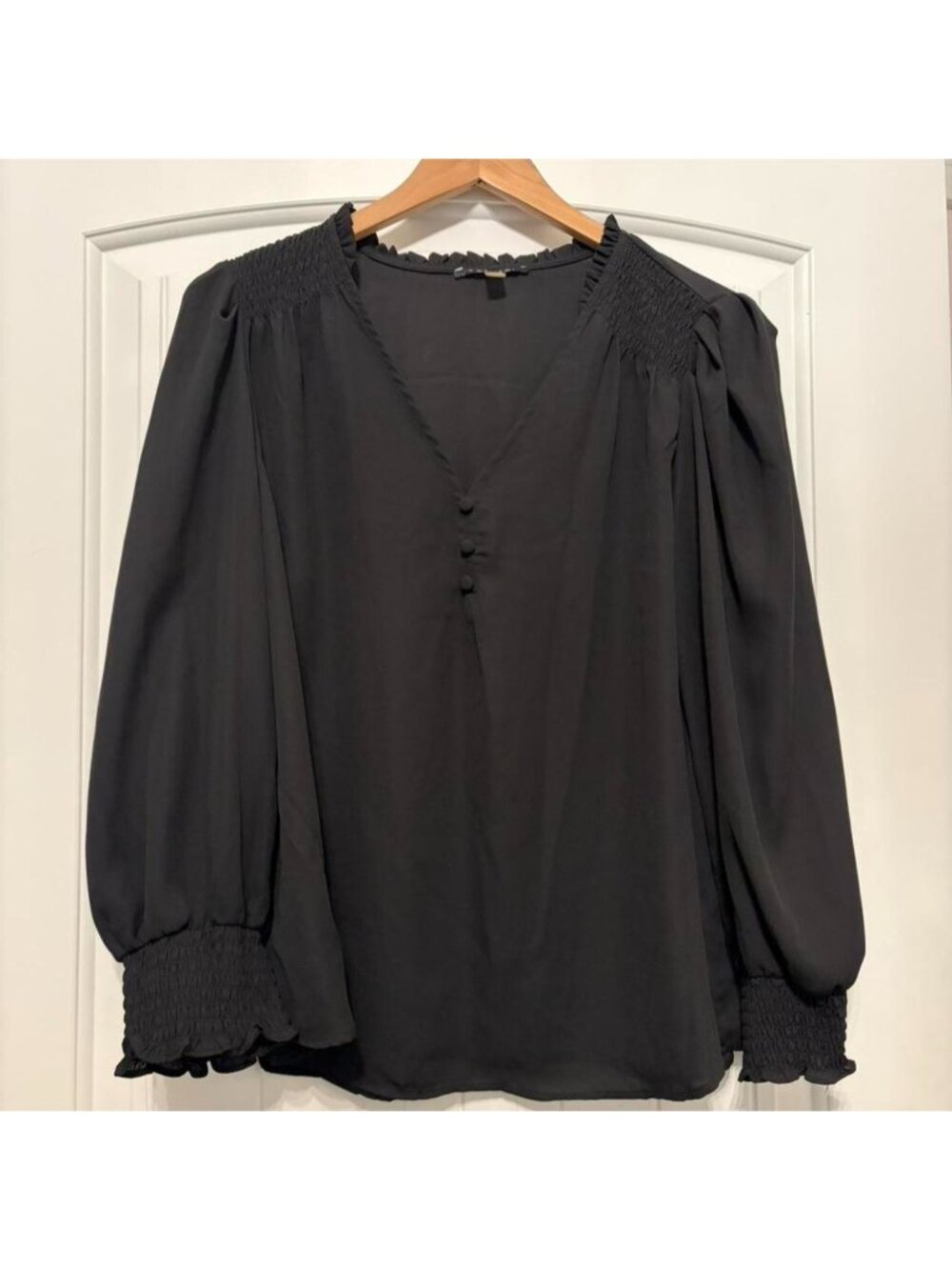 Tahari black blouse with button front and ruffle details.